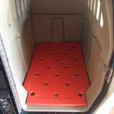 Orange kennel mat inside a kennel showing notches cut out